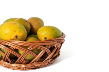 indian mangos in a basket on a white background