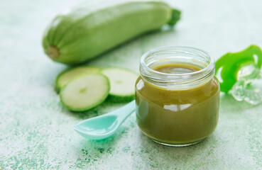 Jar with healthy baby food and zucchini