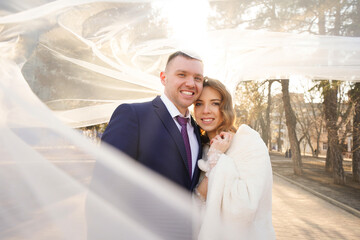 Fototapeta premium happy and romantic bride and groom under the veil. 
