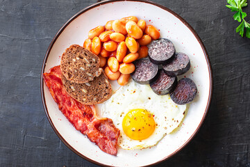 english breakfast fried egg black pudding blood sausage, cereal bread, beans scrambled eggs, on the table wholesome food healthy meal snack copy space food background rustic. top view