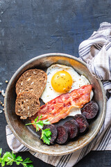 english breakfast fried egg black pudding blood sausage, cereal bread, beans scrambled eggs, on the...