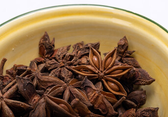 Star anise in a vintage ceramic bowl