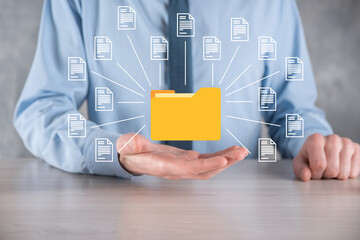 Document Management System DMS .Businessman hold folder and document icon.Software for archiving, searching and managing corporate files and information.Internet Technology Concept.Digital security.
