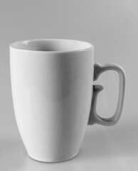 Gray cup with a handle on a gray background