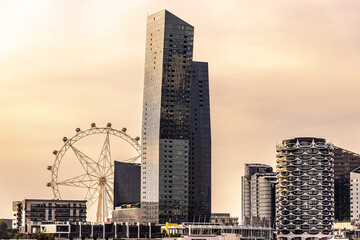 The skyline at Docklands in Melbourne, Australia with an office building with a angular construction in the afternoon golden light