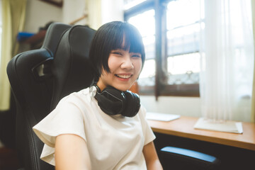 Young adult asian woman stay at home  wear headphone indoor on day.