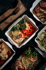 Fototapeta na wymiar healthy food daily ration delivery concept. varied diet top view. food in paper disposable dishes. example of takeaway, food delivery and catering food.