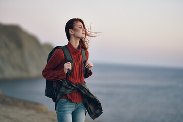 Traveler sweaters with backpack on the back and mountains in the background beach ocean