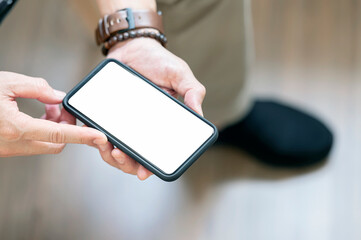 Closeup view of man hands holding blank screen smartphone.