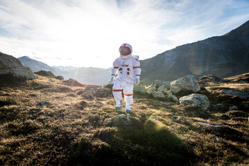 Fototapeta premium Astronaut exploring a new planet. Searching for a new home for humanity. Concept about science and nature