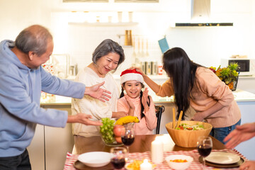 Asian big family sing a song while preparing foods for Christmas party