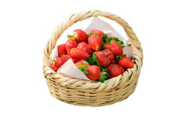 Sweet ripe strawberries in straw basket isolated on white. 