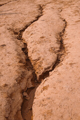 Natural landscape of cracks in red dry ground looks like martian landscape. Textured background.