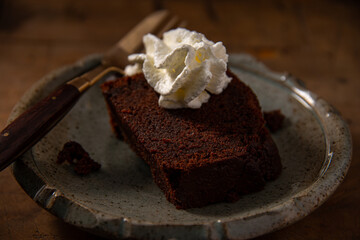 home made chocolate cake or browny with cream on wooden table ,unhealthy eating