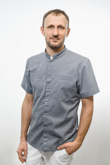 Portrait of friendly gray doctor in grey robe isolated over white background
