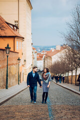 Fototapeta na wymiar Loving young couple walking around Prague, Czech Republic