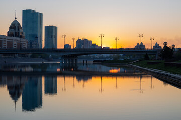 Fototapeta premium The first rays of sunlight over the bridge Sary-Arka and Ishim River in Nur-Sultan, Kazakhstan.