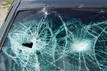 Cracks on the broken windshield of a car after an accident.