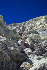 Steep volcano crater walls and the dangerous road, where many travelers hiked, climbing up to the top of Mount Ijen or descending to the bottom of sulfur crater. 
Banyuwangi, East Java, Indonesia. 