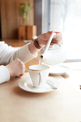 Relaxed caucasian woman drink tea or coffee. Enjoying time in cafe