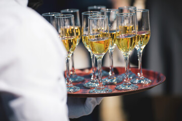 Shallow depth of field (selective focus) details with a waiter walking around and giving sparkling...