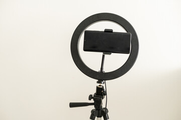 Modern circular neon led lamp for make-up artist or photographers on gray concrete background