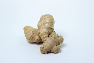 Ginger on a white background. Ginger root. Three whole ginger lie next to each other