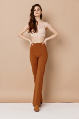 Fototapeta premium skinny woman in pants and bra boots waist hairstyle