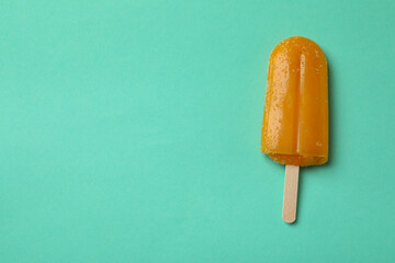 Mango or caramel ice cream stick on mint background