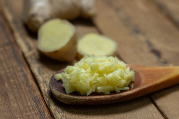 Ginger on a wooden background. Chopped ginger root. Healthy food. Healthy food concept