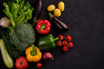 Tasty and healthy food. Fresh and juicy multicolored vegetables on a black background