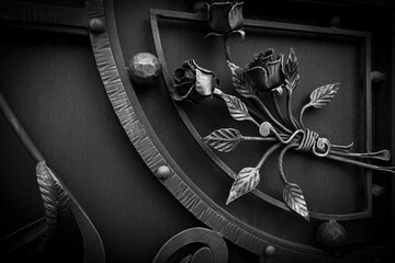 Decorative forged elements of metal gates in dark colors