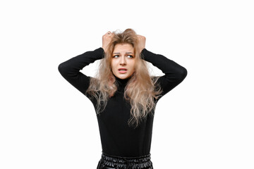 Scared and worried young blonde woman panicking, holding hands on head and look nervous, standing over white background