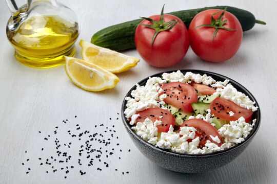 Chopped tomatoes and cucumbers with cottage cheese and black cumin seeds