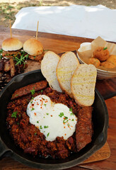 Pulled pork burger served with deep fried cheeseball and ground beef
