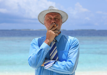man with a cigar on a tropical island