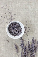 Lavender dry herb in a bowl with flowers nearby, closeup, from above overhead top view, natural medicine, naturopathy, organic cosmetics, sleep tea, skin and hair care concept