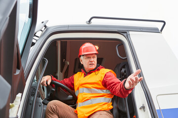 Worker as a truck driver in the cab