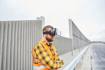 Workers with VR glasses on the road construction site