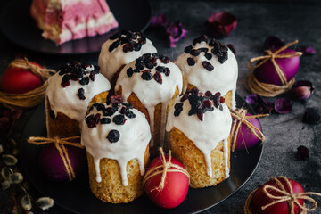 Easter cake. A traditional Orthodox dish for Easter. Easter cake with dried apricots, raisins and icing. Easter composition with painted eggs 