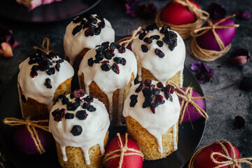 Easter cake. A traditional Orthodox dish for Easter. Easter cake with dried apricots, raisins and icing. Easter composition with painted eggs 