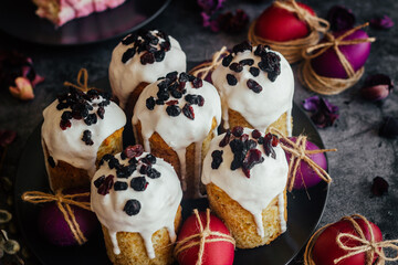 Easter cake. A traditional Orthodox dish for Easter. Easter cake with dried apricots, raisins and icing. Easter composition with painted eggs 