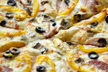Pizza slices with chesse, ham, yellow bell pepper, olives and mushrooms, background , closeup