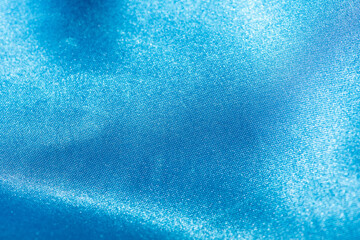 Obraz premium Abstract blue silk fabric texture background. Cloth soft wave. Creases of satin