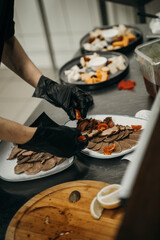 Male chef hands in black gloves preparing dishes