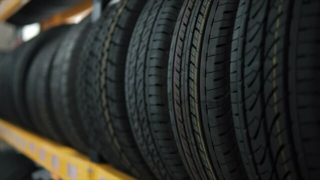 Car tires on rack in auto store, Close up of Car wheels at the auto repair shop.