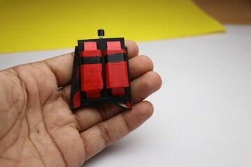 Foldable cardboard falcon wings craft held in hand. Homemade creative cardboard craft ideas concept
