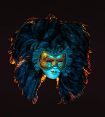 Mask depicting the face of a girl in a mask with feathers instead of hair in colored lighting