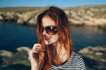 happy traveler wearing sunglasses on vacation in the mountains in nature