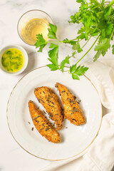 Fried filet of fish with lemon vinaigrette. White background